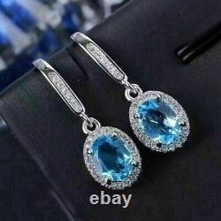 Boucle d'oreille pendante en forme de goutte époustouflante en topaze bleue simulée à taille ovale plaquée or blanc 14 carats